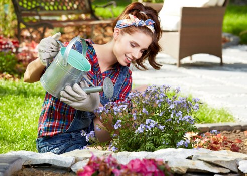 Volunteer demonstrating garden landscaping with clear signage for visitors