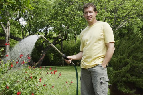 Team member sorting garden waste into labelled containers at a London garden site