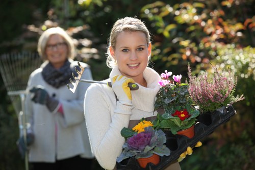 Gardeners wearing PPE including gloves and high visibility clothing